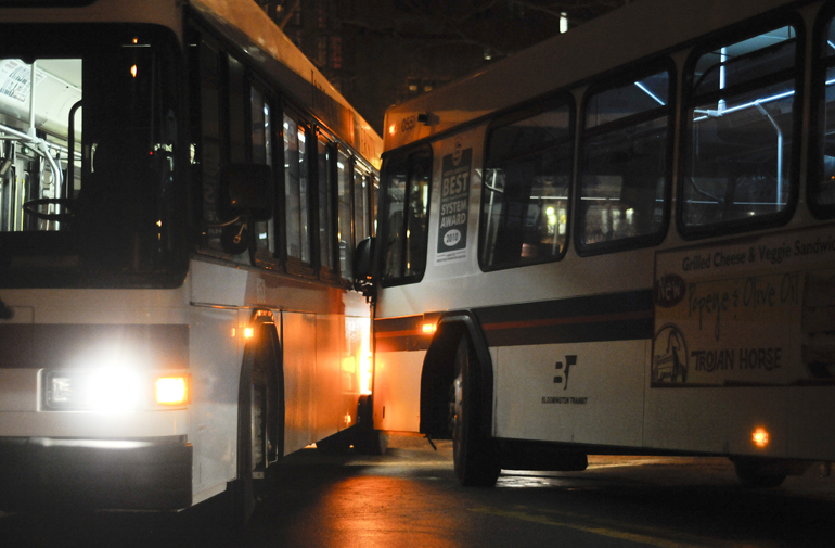 An Indiana University B bus and a Bloomington Transit 6 bus are stopped after bumping into each other at 7:30 p.m. Feb. 21, 2011, at Seventh Street and Woodlawn Avenue. Campus Bus student superviser Skylar Earley advised all other campus buses besides the X bus to continue driving up Indiana Avenue and turning right on Tenth Street, skipping the stop at the Indiana Memorial Union. The B bus was able to turn and clear the intersection by 8 p.m.