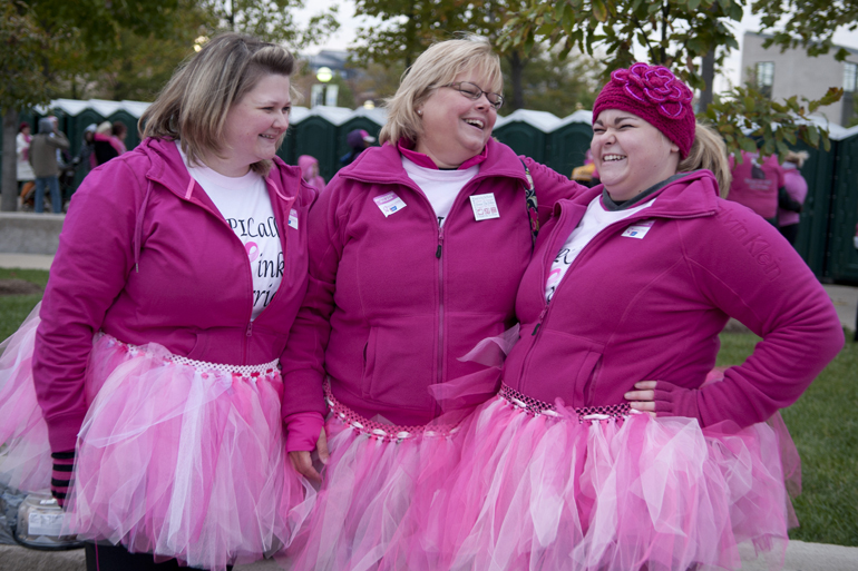 Adrienne, Laura and Mallory Eckart talk while wearing handmade pink tutus before the Making Strides Against Breast Cancer 5K walk downtown, Saturday, Oct. 26, 2013. Adrienne Eckart made the tutus.