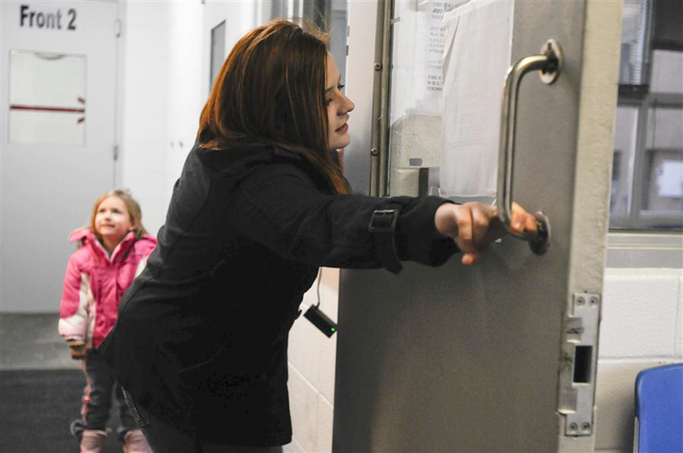 Brittney Hamm closes the Front 1 door before talking to her fiance, Jere, on Feb. 14, 2011, in the Monroe County (Indiana) Correctional Facility. Jere was arrested seven months ago and charged with theft on the Indiana University-Bloomington campus. (Alex Farris | Indiana Daily Student)