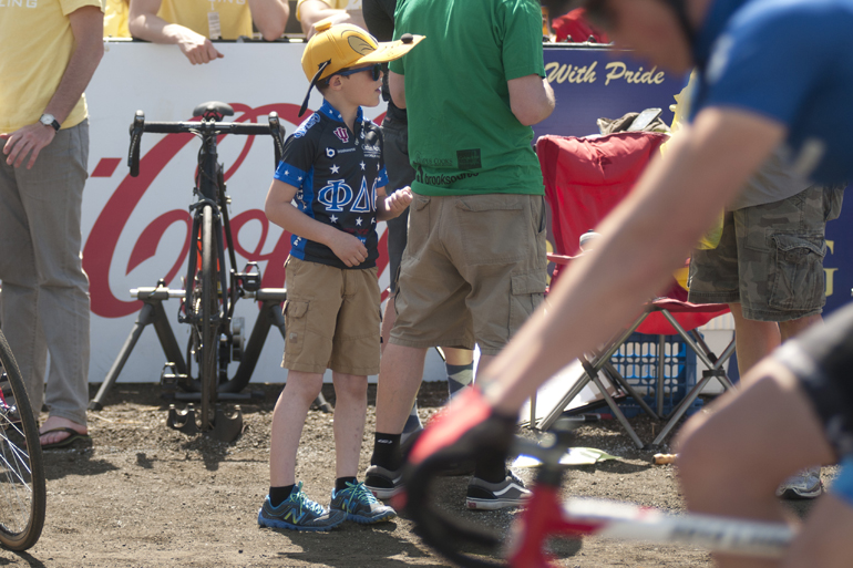 Miles McKay, 7, son of Phi Delta Theta coach Joel McKay, watches riders circle the track before the men\'s Little 500 at Bill Armstrong Stadium in Bloomington, Saturday, April 26, 2014.