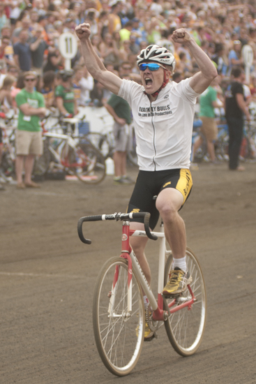 Jacob Miller celebrates as he crosses the finish line, bringing Black Key Bulls its first victory in the men\'s Little 500 at Bill Armstrong Stadium in Bloomington, Saturday, April 26, 2014.