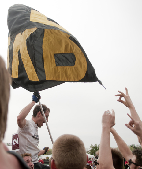Steven Gomez waves the Black Key Bulls flag in celebration of the team\'s first victory in the men\'s Little 500 at Bill Armstrong Stadium in Bloomington, Saturday, April 26, 2014.