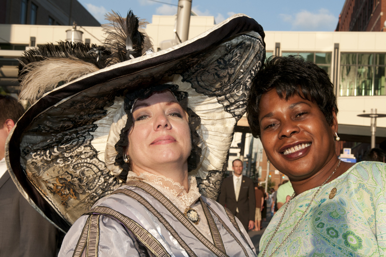 Omni Severin Hotel senior sales manager Terri Louk poses with visitor Cheryl McClendon during the hotel\'s 100th anniversary party on Georgia Street, Friday, August 23, 2013.