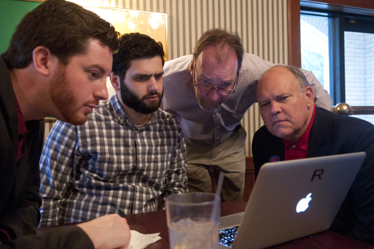 Collin Corbett, Ryan Kilduff, Rick Sharp and Briane House huddle around a computer to watch for updates at the Sharp results party at Dooley O\'Toole\'s as votes come in for the Republican primary for the Carmel mayoral race between incumbent Jim Brainard and City Council president Rick Sharp, Tuesday, May 5, 2015.
