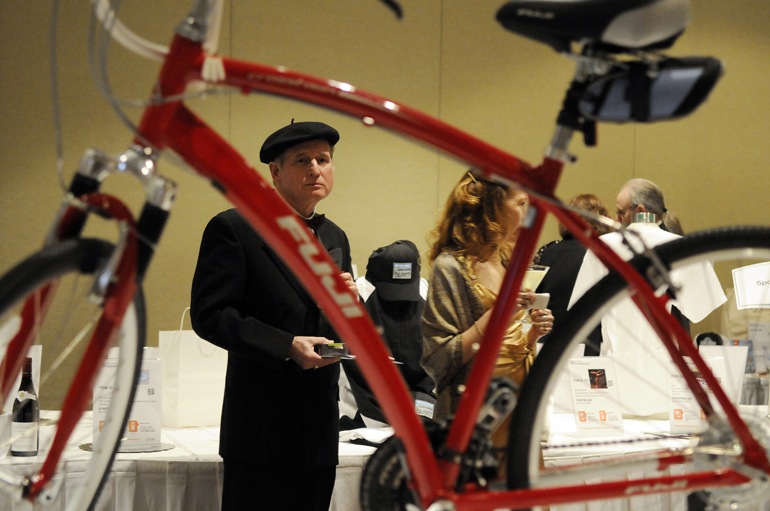 John Knighton looks toward a bike donated for auction by Dennis Ryerson during Dance Kaleidoscope\'s \