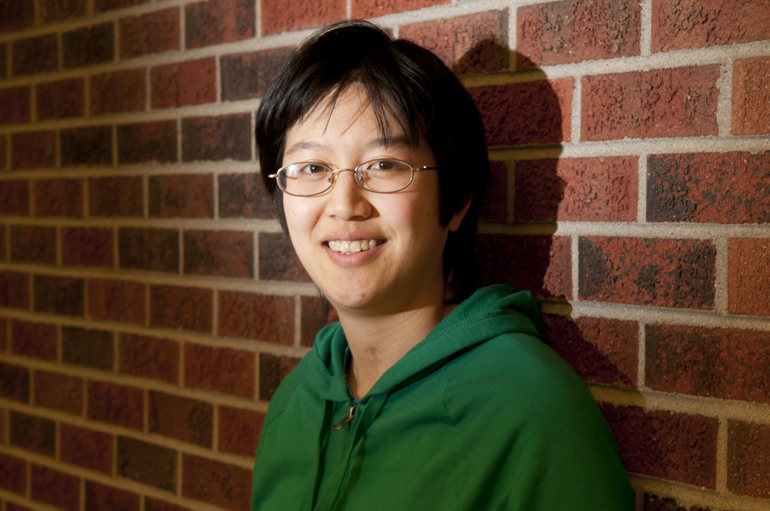 Purdue doctoral student Mallory (Mel) Chua, diagnosed with severe-to-profound hearing loss at age 4, is a candidate for an Oticon Focus on People Award for people with hearing loss. Chua has worked with open-source code company Red Hat and the One Laptop Per Child project, toured through Italy as a cellist, and currently performs with Purdue\'s Contemporary Dance Company. She stands for a portrait on Thursday, March 28, 2013, in Amelia\'s Cafe in the Neil Armstrong Hall of Engineering.