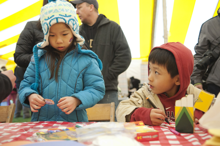 Mia Blacker, 7, chooses a sticker as Simon Mao, 6, looks up from his coloring during Purdue University\'s Spring Fest on Saturday, April 13, 2013, on the Purdue campus.