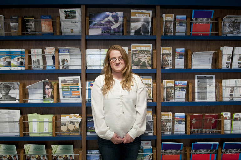 Student counselor Jennifer McVeigh stands in front of information for students on Wednesday, April 3, 2013, outside her office at Schleman Hall of Student Services at Purdue. The National Student Employment Association recognized student employees like McVeigh during National Student Employment Week, from April 7 to April 13.