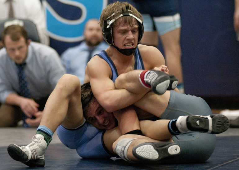 Jordan Napier of Perry Meridian wraps up the 132 lbs. championship match with Matthew McKinney of Warren Central during a high school wrestling regional meet at Perry Meridian High School, Saturday, Feb. 7, 2015.