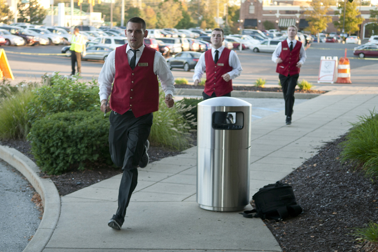 Josh Young of Elite Management Services leads valet drivers back from the parking lot during the Key to the Cure Gala at Saks Fifth Avenue in Indianapolis, Friday, Oct. 11, 2013.