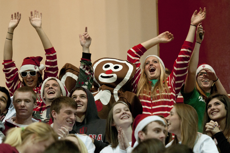 IU students cheer as they see themselves on the big screen before IU\'s game against the University of North Florida at Assembly Hall in Bloomington, Saturday, Dec. 7, 2013.