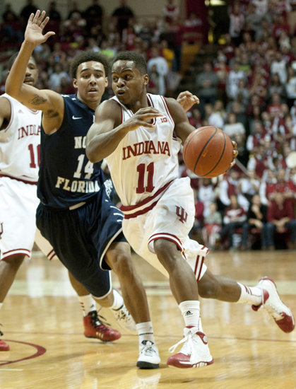 Hoosier guard Yogi Ferrell drives past North Florida guard Dallas Moore during IU\'s 89-68 victory against the University of North Florida at Assembly Hall in Bloomington, Saturday, Dec. 7, 2013.
