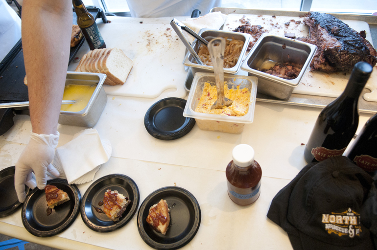 North End Barbecue and Moonshine spreads out its sandwich ingredients during the Taste of the NFL Sandwich Cook-off at Recess on North College Avenue, Sunday, Jan. 4, 2015.