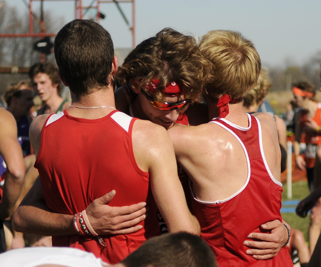 Kenny and another teammate hug Kevin McCarthy after they learn that McCarthy won the race.