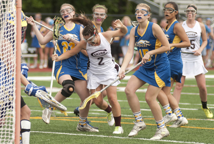 Culver attacker Olivia Rabbitt trips after a shot attempt during Culver\'s 9-8 victory over Carmel in the Indiana Girls Lacrosse Association state championship at Brebeuf Jesuit Preparatory School in Indianapolis, Saturday, June 1, 2013.