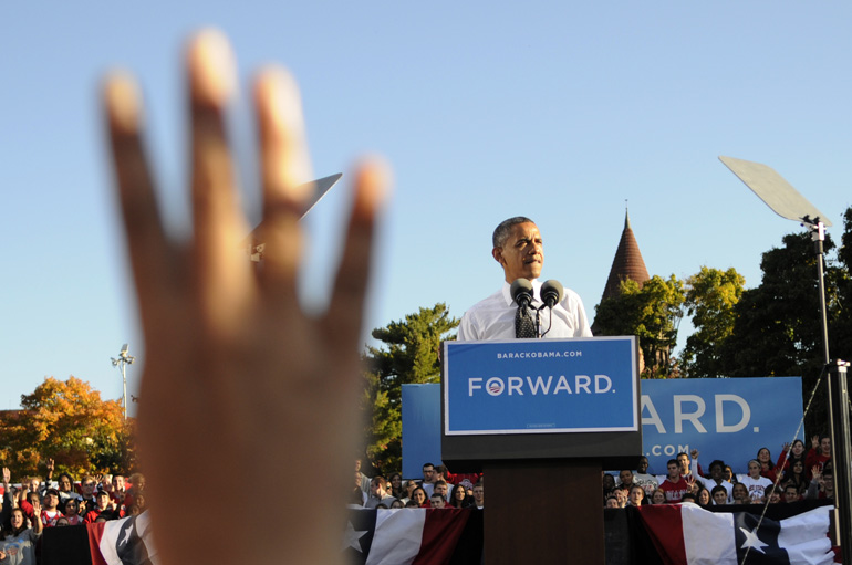 A supporter holds up four fingers as U.S. President Barack Obama speaks during a presidential campaign stop at the Ohio State University in Columbus, Ohio.