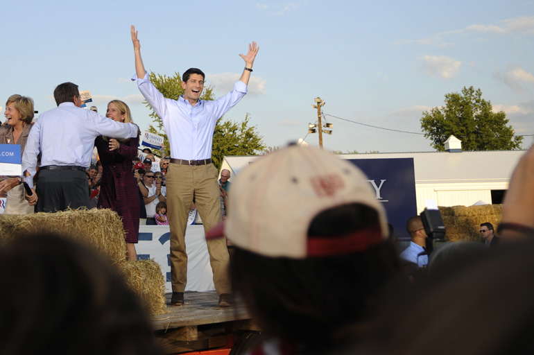 Before his speech, Paul Ryan shows excitement and embrace by raising his arms and giving a 
