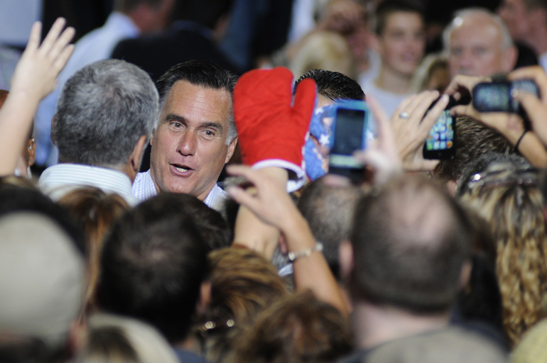 Former Mass. Governor Mitt Romney shakes hands as a supporter holds out an oven mitt during a presidential campaign stop Sept. 26 in Toledo, Ohio.