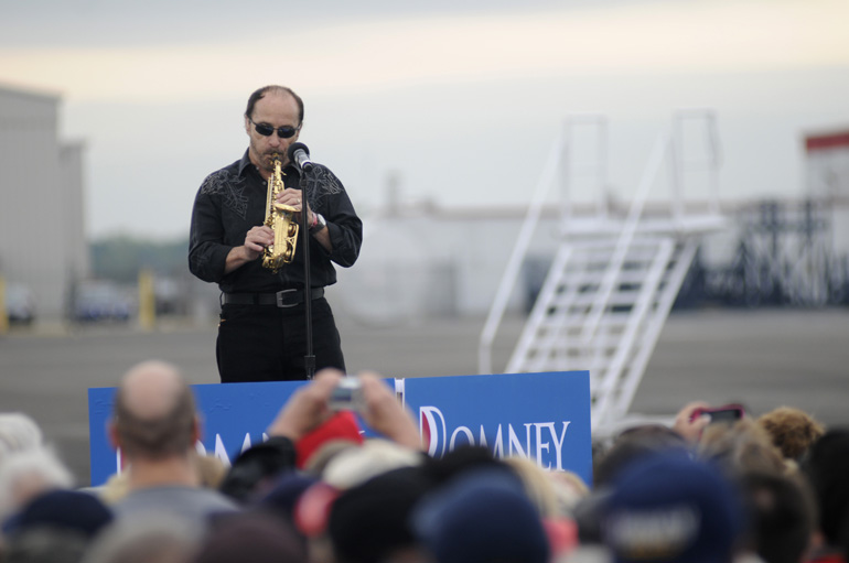 Musician Lee Greenwood plays the saxophone before a Romney/Ryan presidential campaign stop Sept. 25 at Dayton International Airport Exposition Center in Ohio.