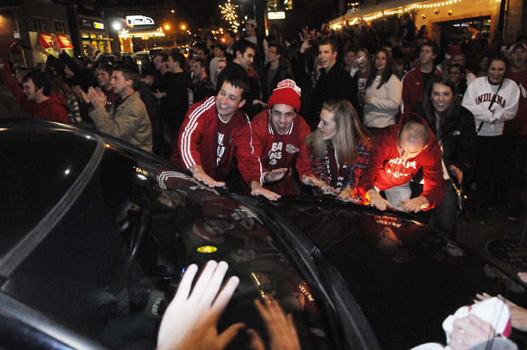 Indiana University basketball fans celebrate in the intersection of Kirkwood Avenue and Dunn Street in Bloomington after the Hoosiers defeated the number one-ranked Kentucky Wildcats, 73-72, on Dec. 10, 2011, in Bloomington.