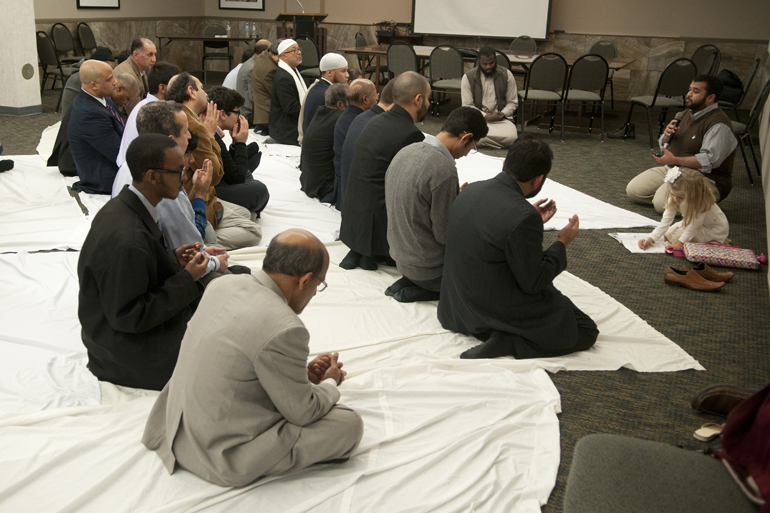 Adil Majid (far right), a member of the Muslim Student Association at Indiana University-Purdue University Indianapolis, leads a prayer of supplication for slain aid worker Abdul-Rahman (Peter) Kassig during a memorial service for Kassig at the Indiana Interchurch Center in Indianapolis, Saturday, Nov. 22, 2014.