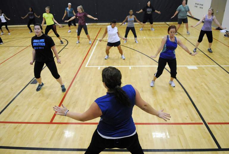 Zumba class instructor Suzi Brown (bottom) leads a class in exercising to V.I.C.'s 